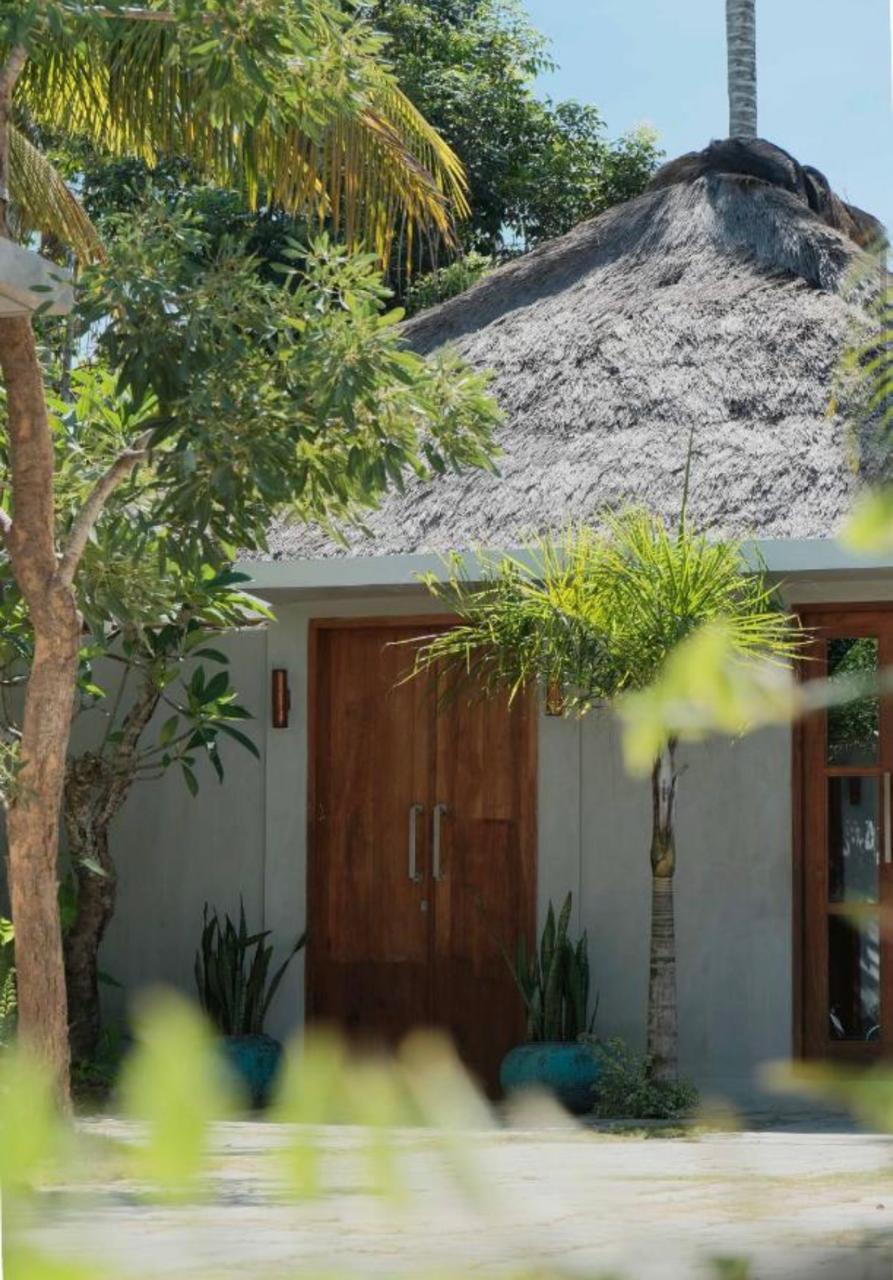 Thatched villa entrance with timber doors